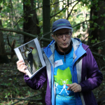 Carolinian Forest Festival educator with a picture of a woodpecker