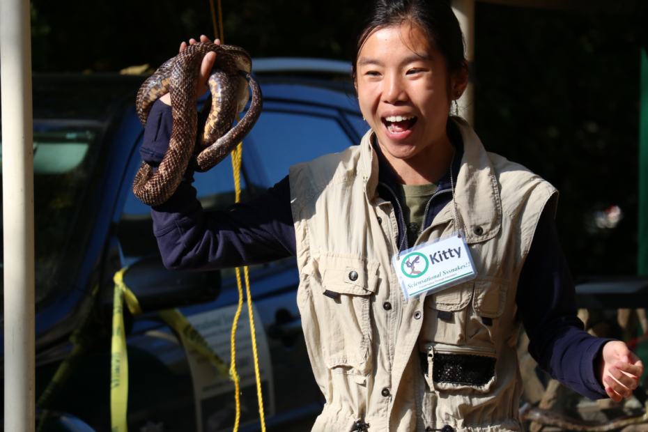 Sci Snake Volunteer holding a snake